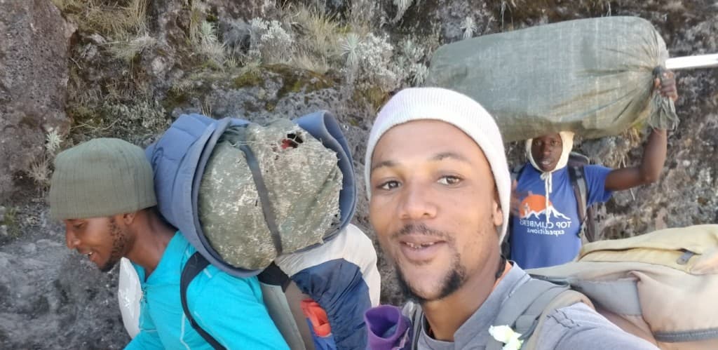 Porters on the trail near Moshi at the foot of Mount Kilimanjaro